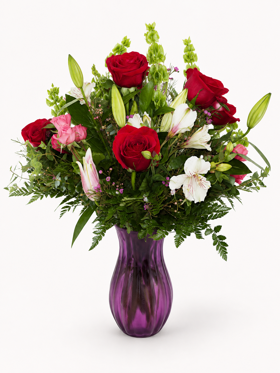 Velvet Kiss romantic red pink and white floral arrangement in a purple vase