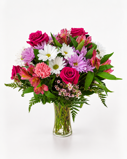 Pink Celebration colorful flower arrangement in a glass vase