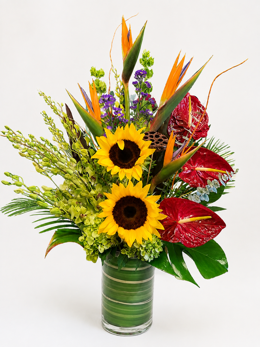 Large colorful tropical flower arrangement with sunflowers and vibrant exotic blooms