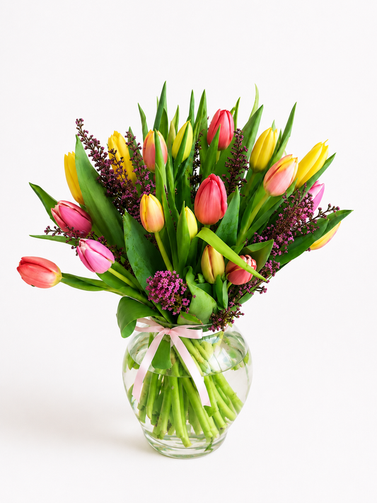 Colorful tulip arrangement in a clear glass vase